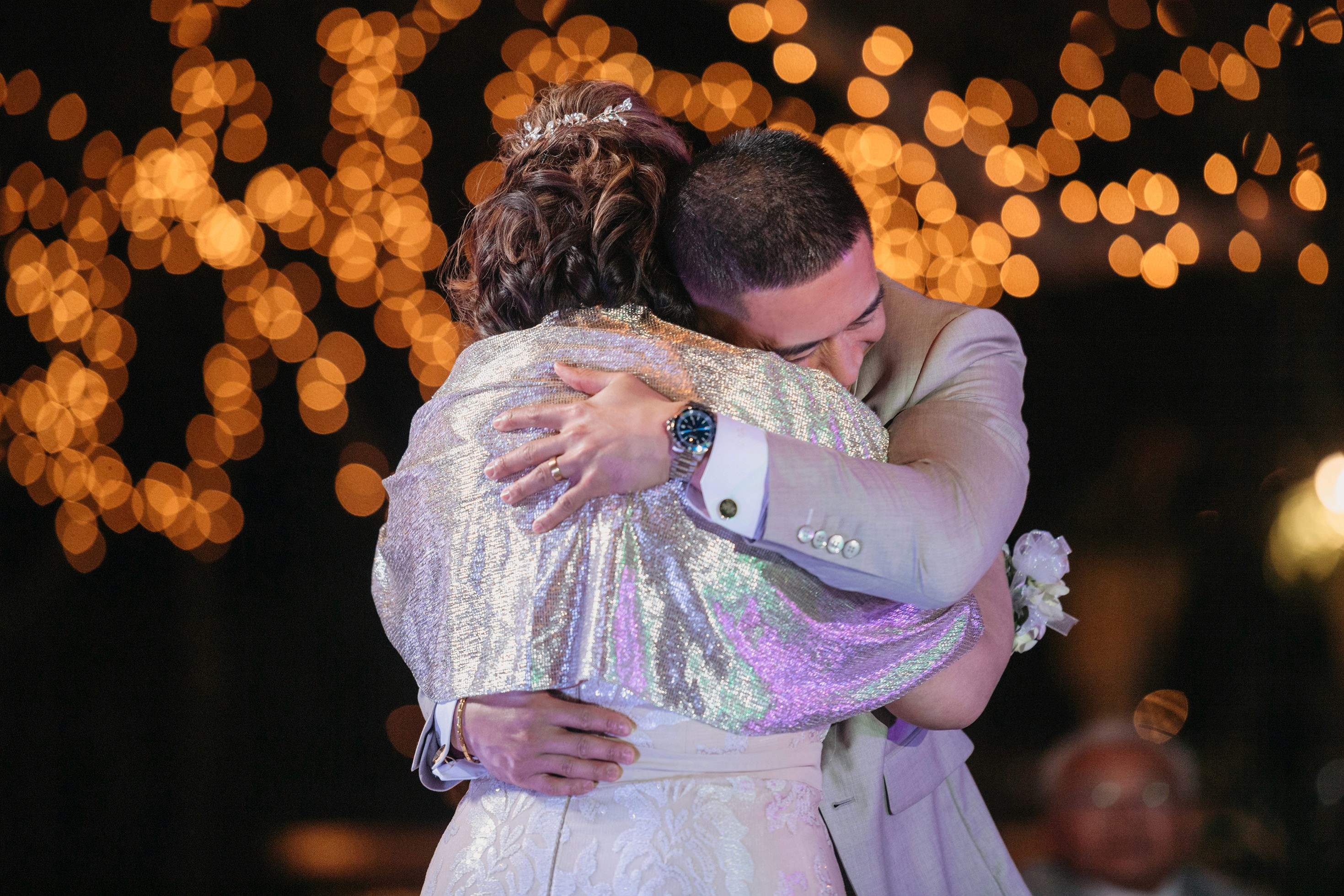Flat lay wedding details with bouquet, rings, and sparkling bridal heels