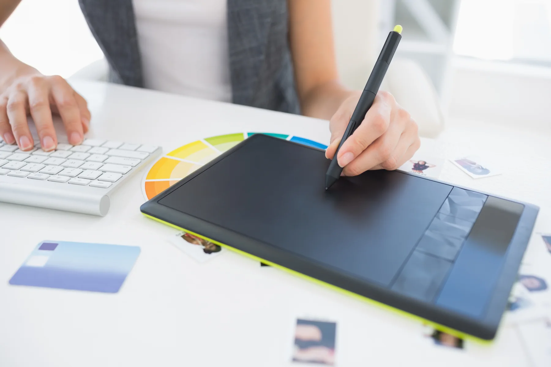 Graphic Designer Using Drawing Tablet at White Desk
