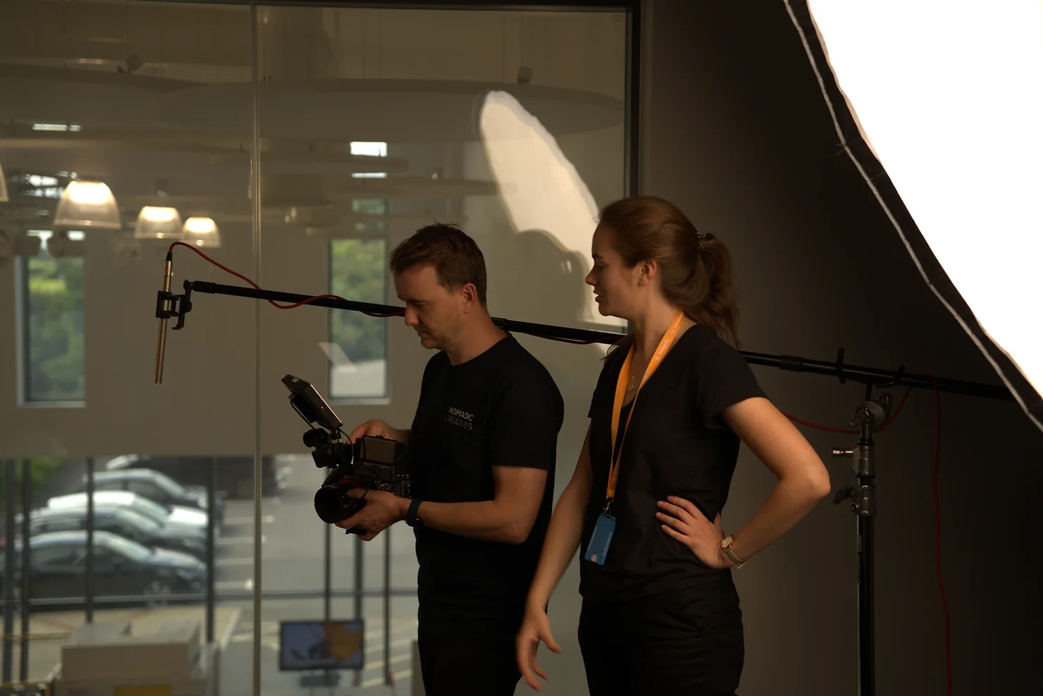 Video production crew filming on set with lighting, tripods and Sony FX6 camera set up