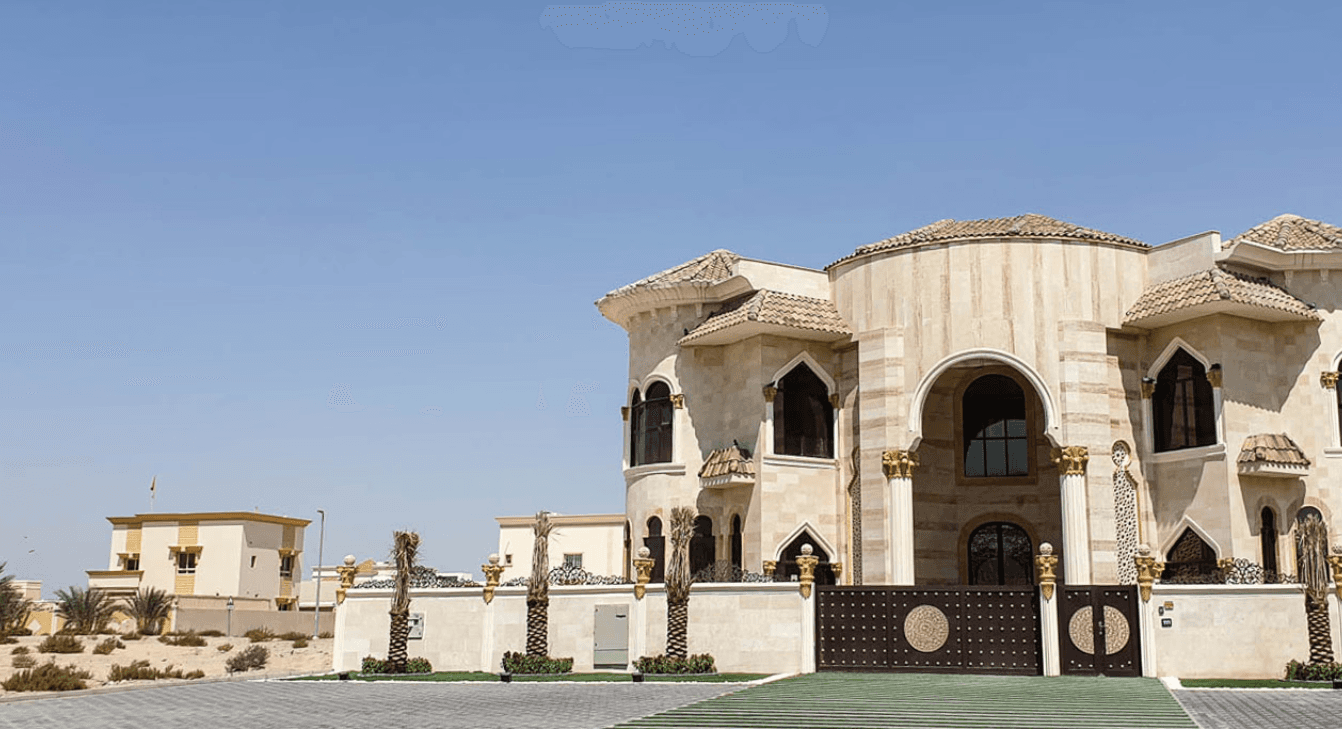 A white house with a car parked in front, located in the Al Rashidiya area.