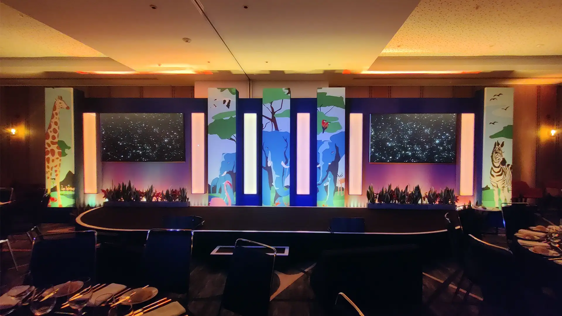 Group of presenters speaking on camera during a Microsoft live broadcast, filmed against branded event graphics.