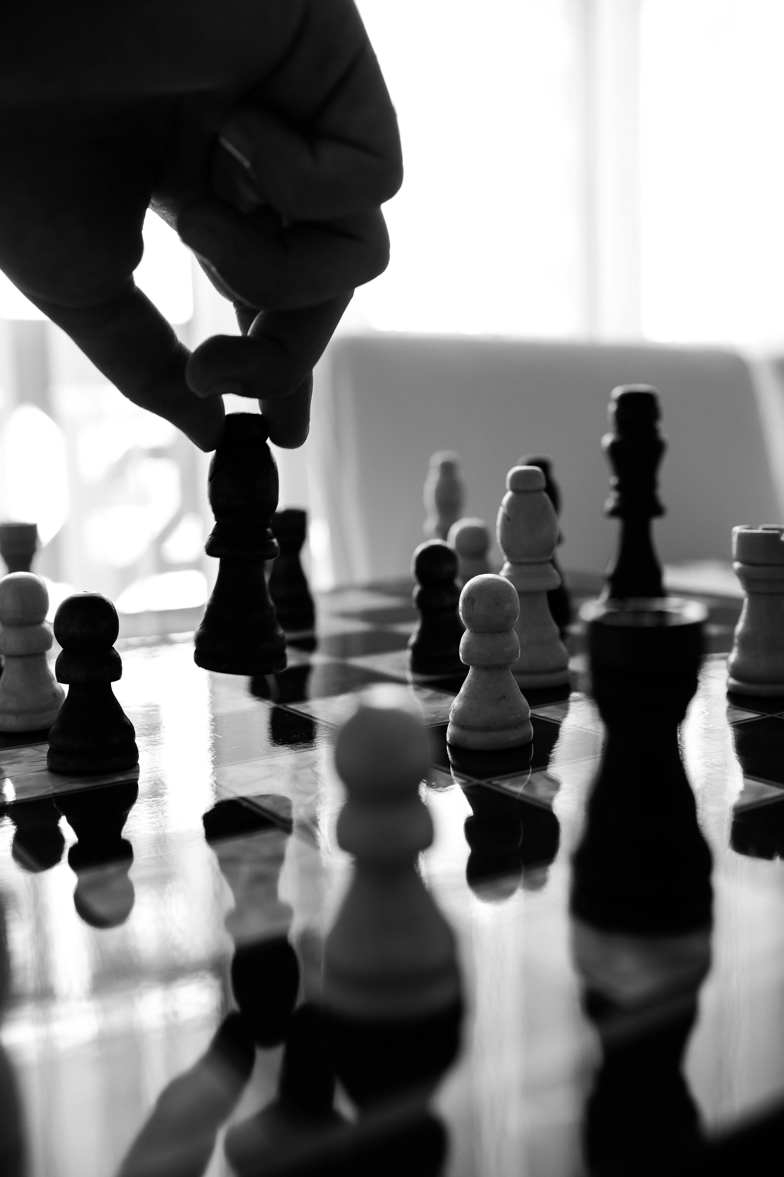 Scientist wearing safety goggles and blue lab attire, using a pipette to transfer liquid into a vial in a laboratory setting.