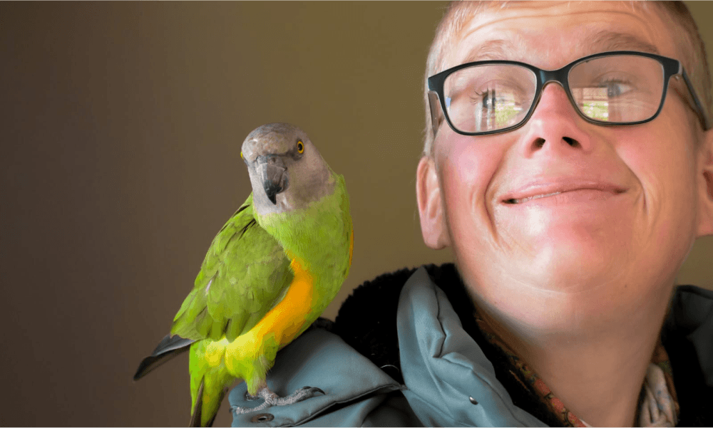 A person with a parrot on his shoulder.