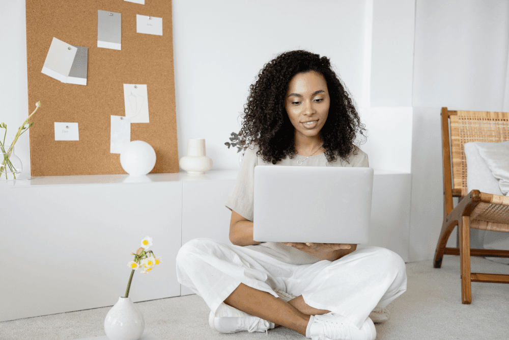 An eLearning specialist focused on her laptop in a modern workspace, launching a new training program and analyzing user data to measure its impact and ensure its success.