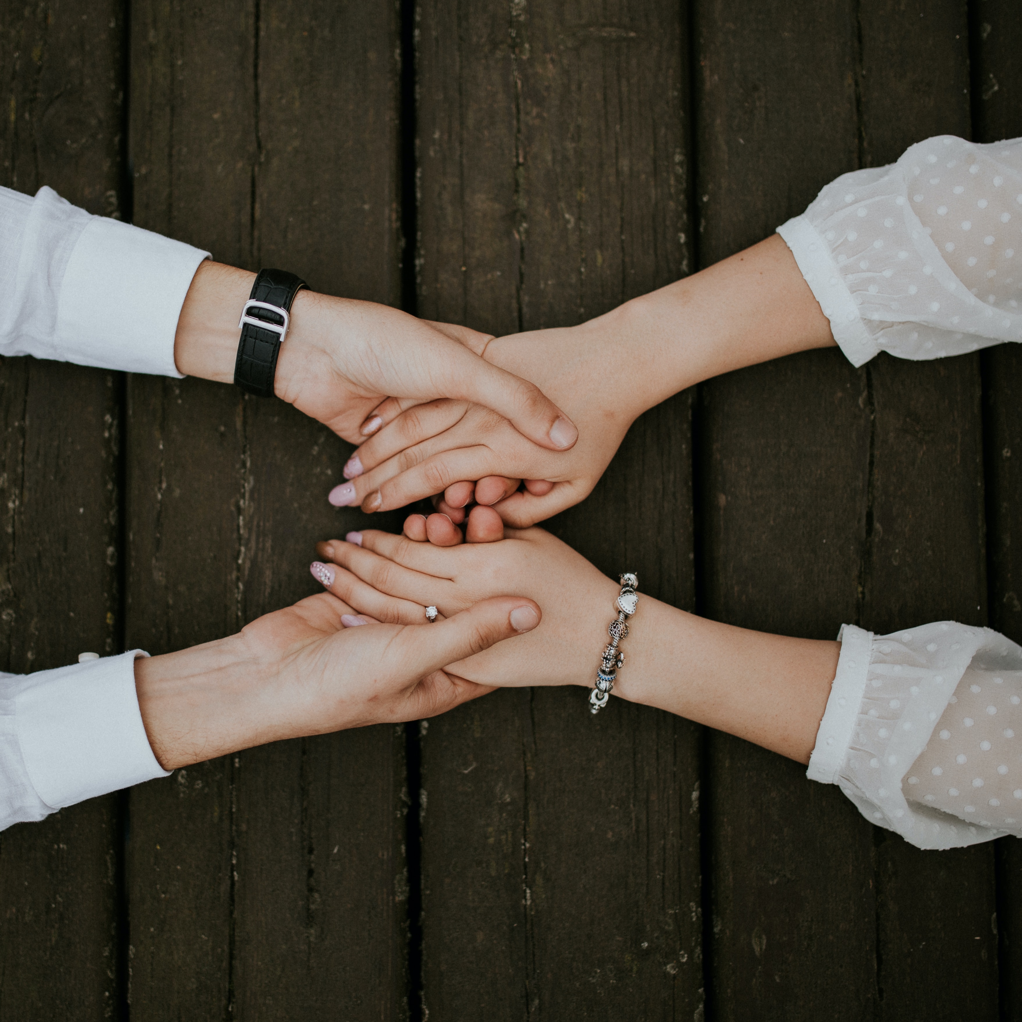 A picture of hands clasped taken from above 