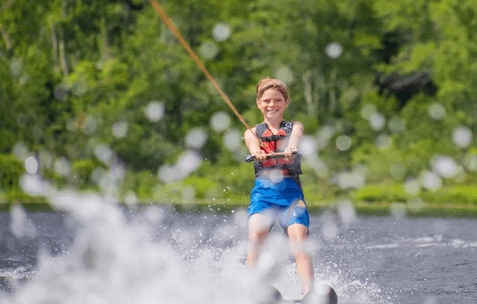 Camper waterskiing on the lake at Camp Lenox