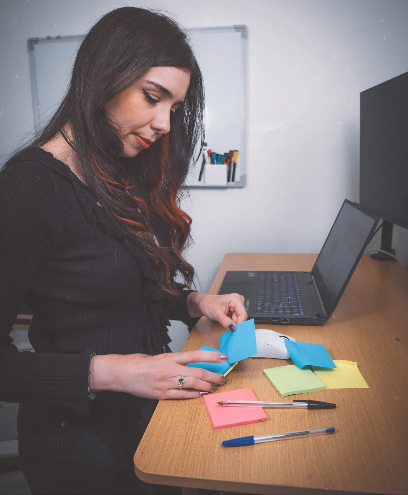 Lorena writing down notes on post-its