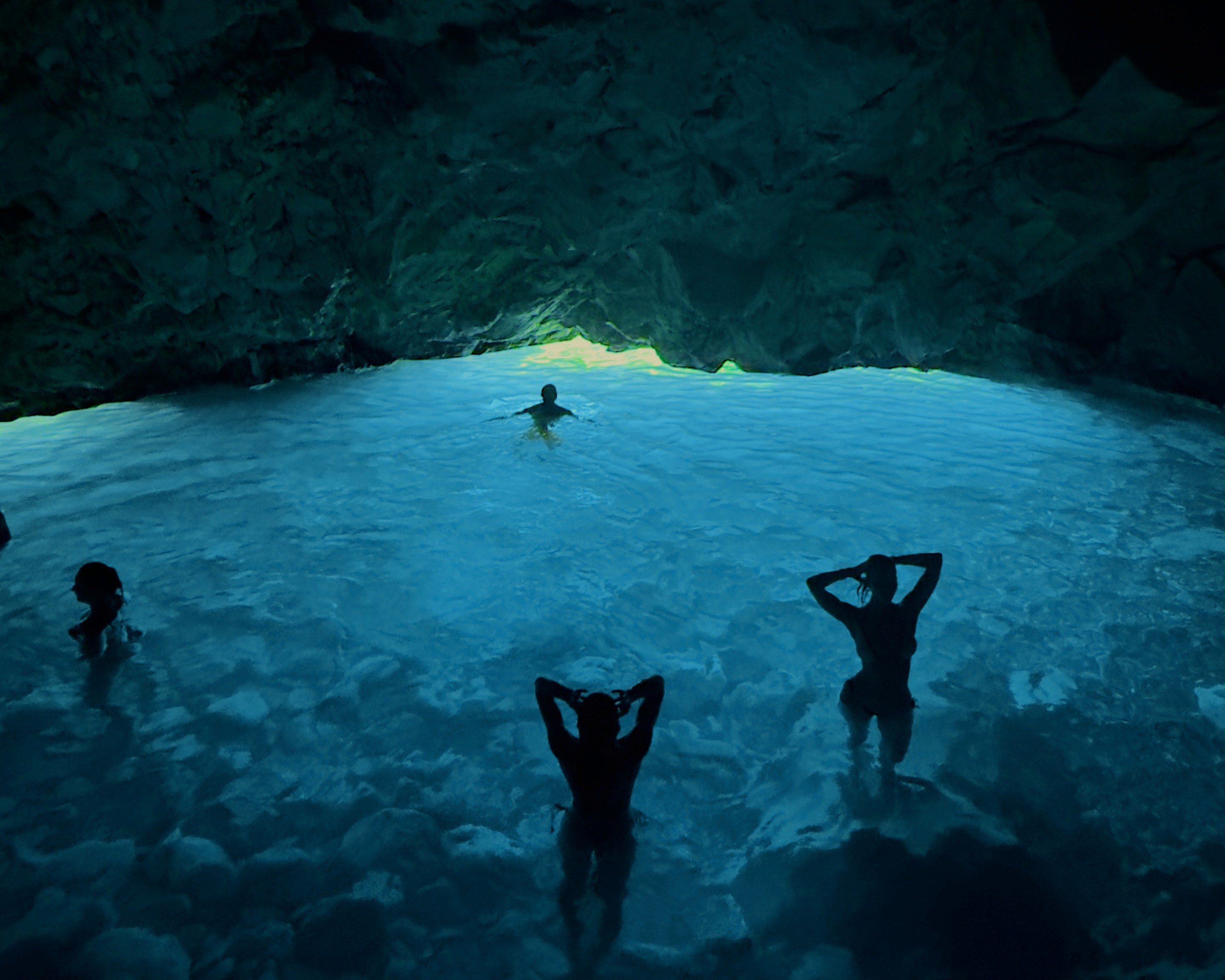 Full width reveal of the glowing blue cave