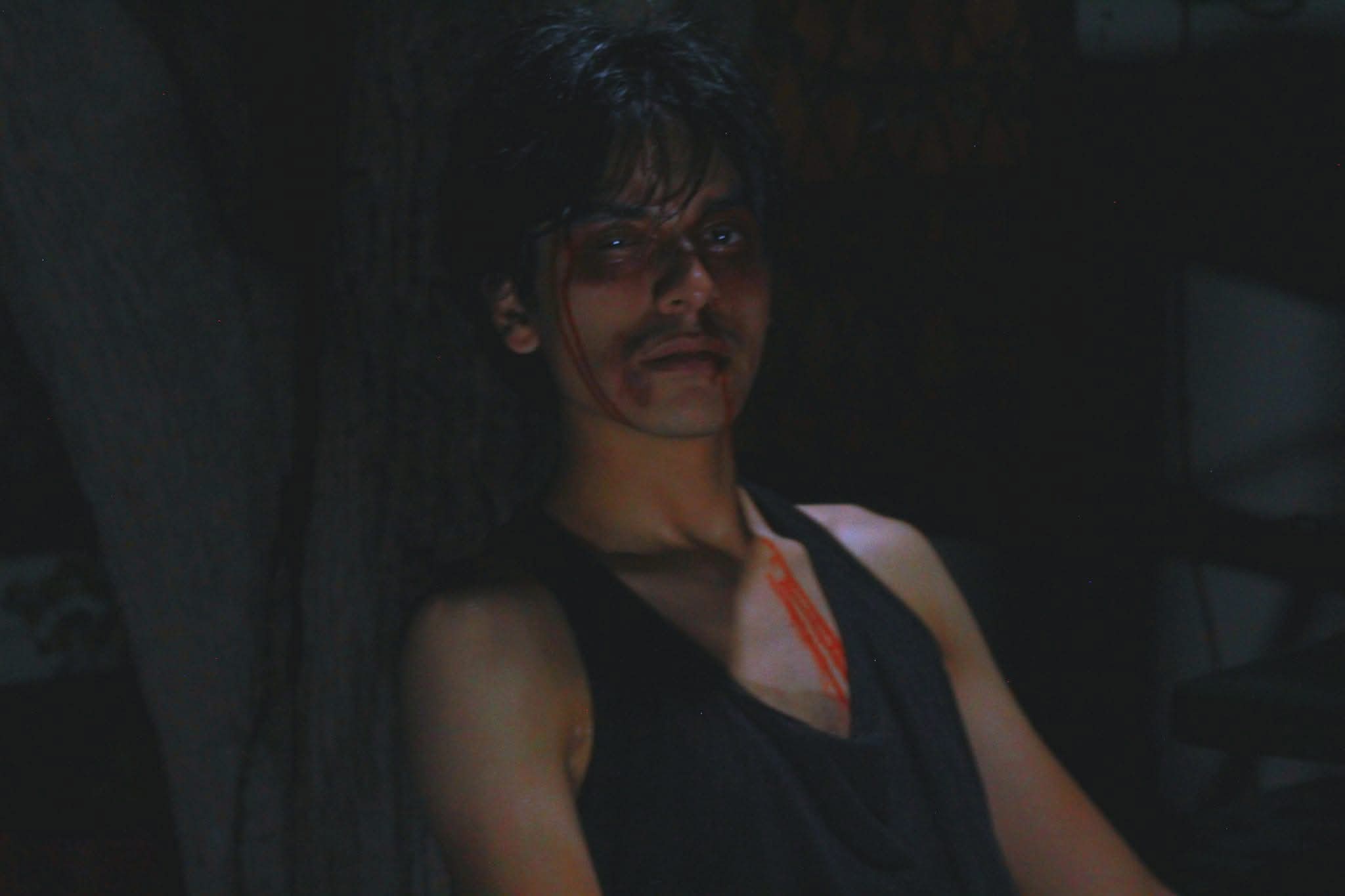 View of the French countryside through a stone villa’s open living room, with sofas and trees framing the scene