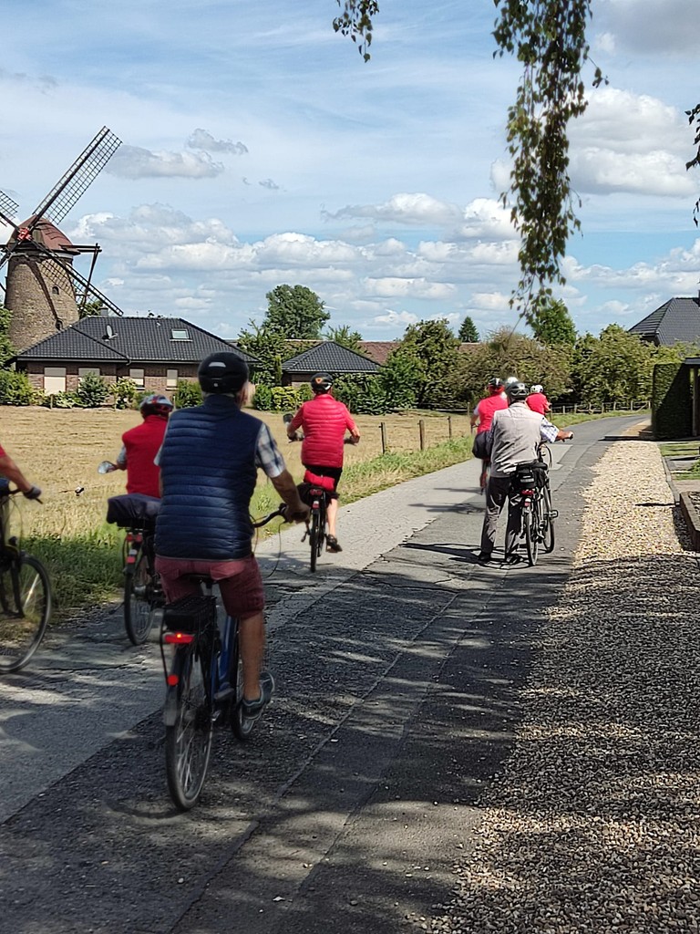 a group of people riding bikes down a road