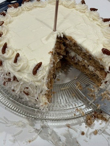 Coconut pecan cake with slice cut out of it