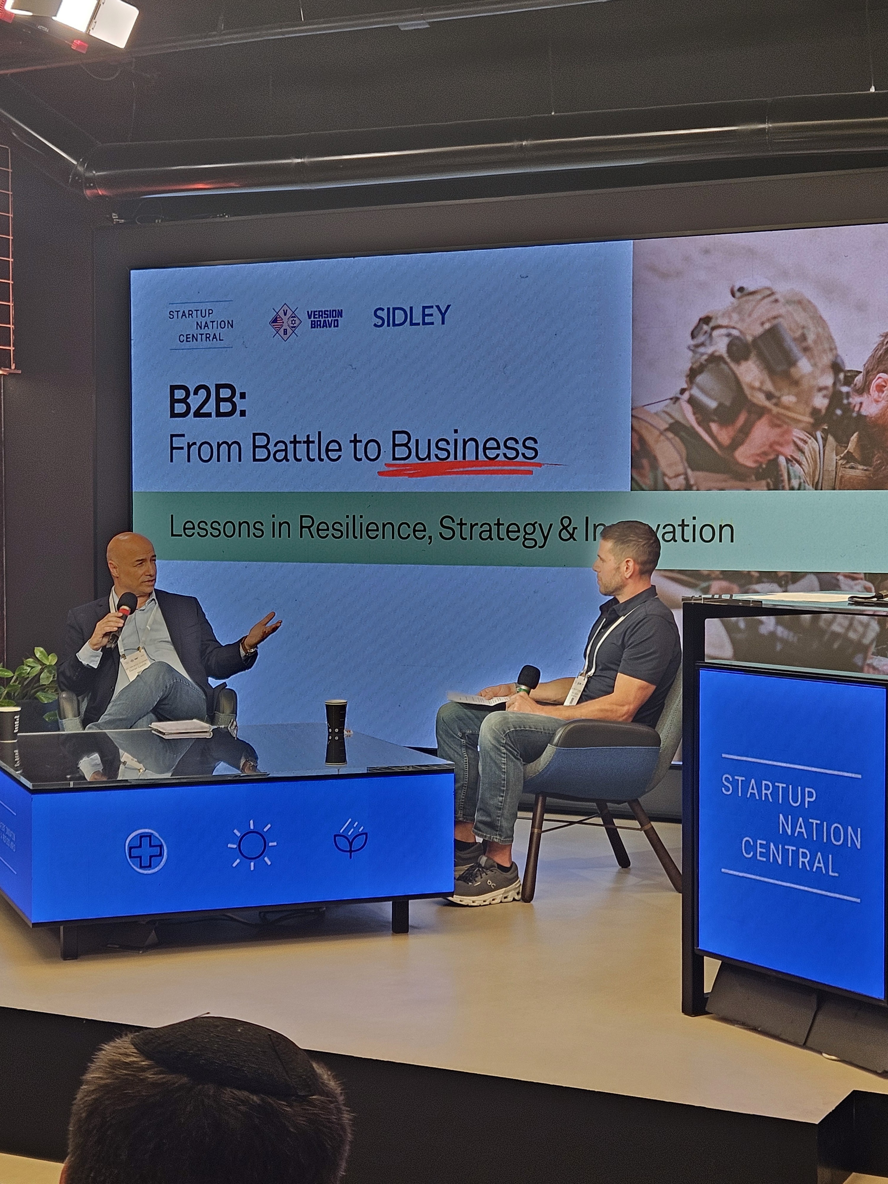men in camouflage uniform standing near white wall