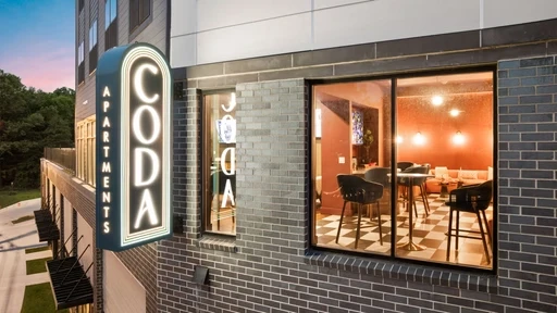 Exterior view of a building featuring a prominent sign that reads "Coda."