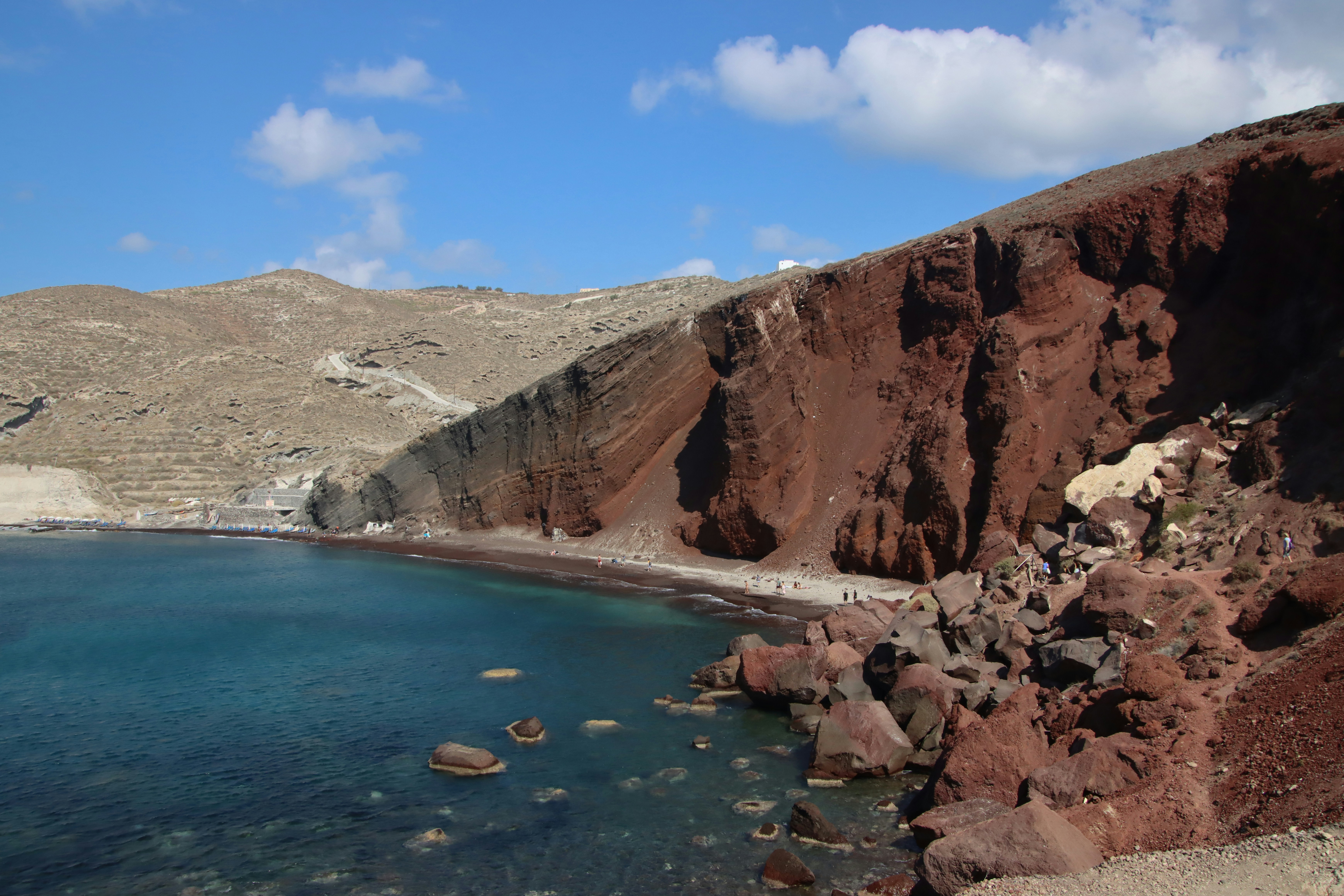 Red Beach: Dramatic Cliffs and Crystal Clear Waters