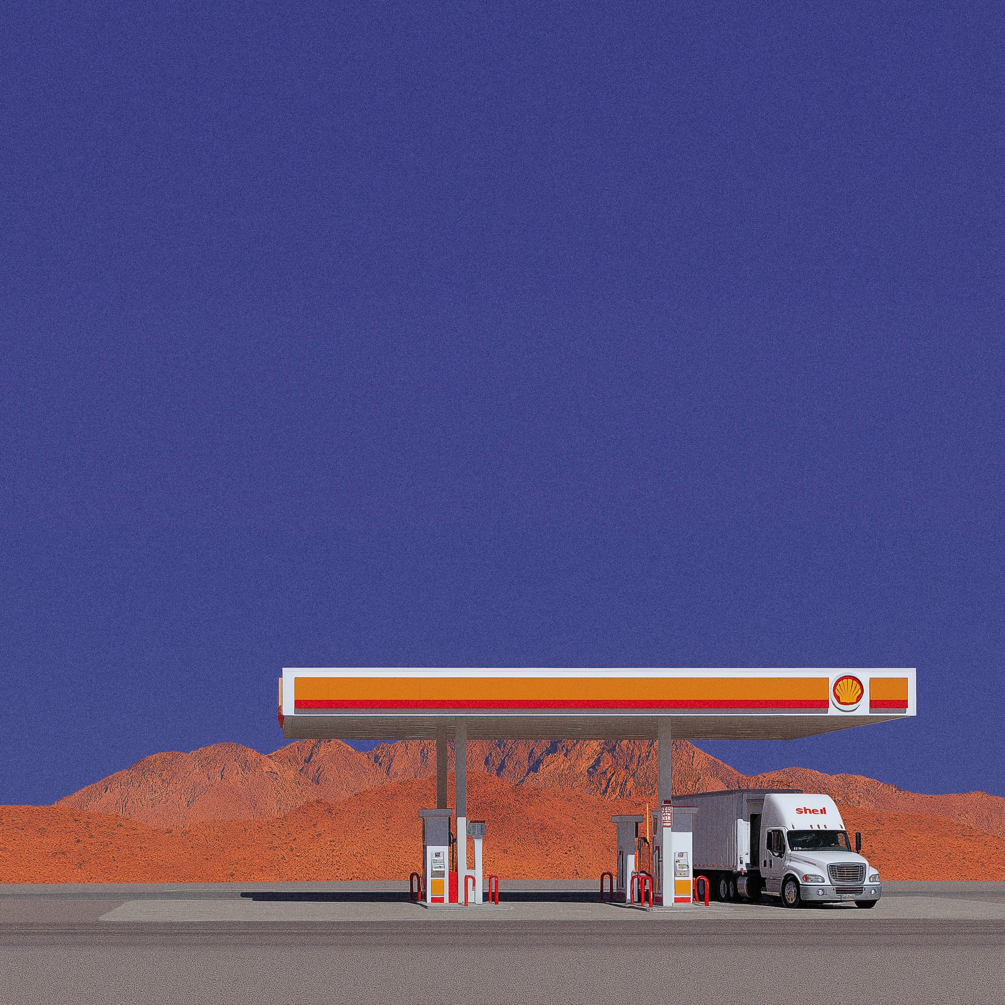 A red-and-white gas station stands alone in a wide open area beneath a deep blue sky with scattered white clouds.