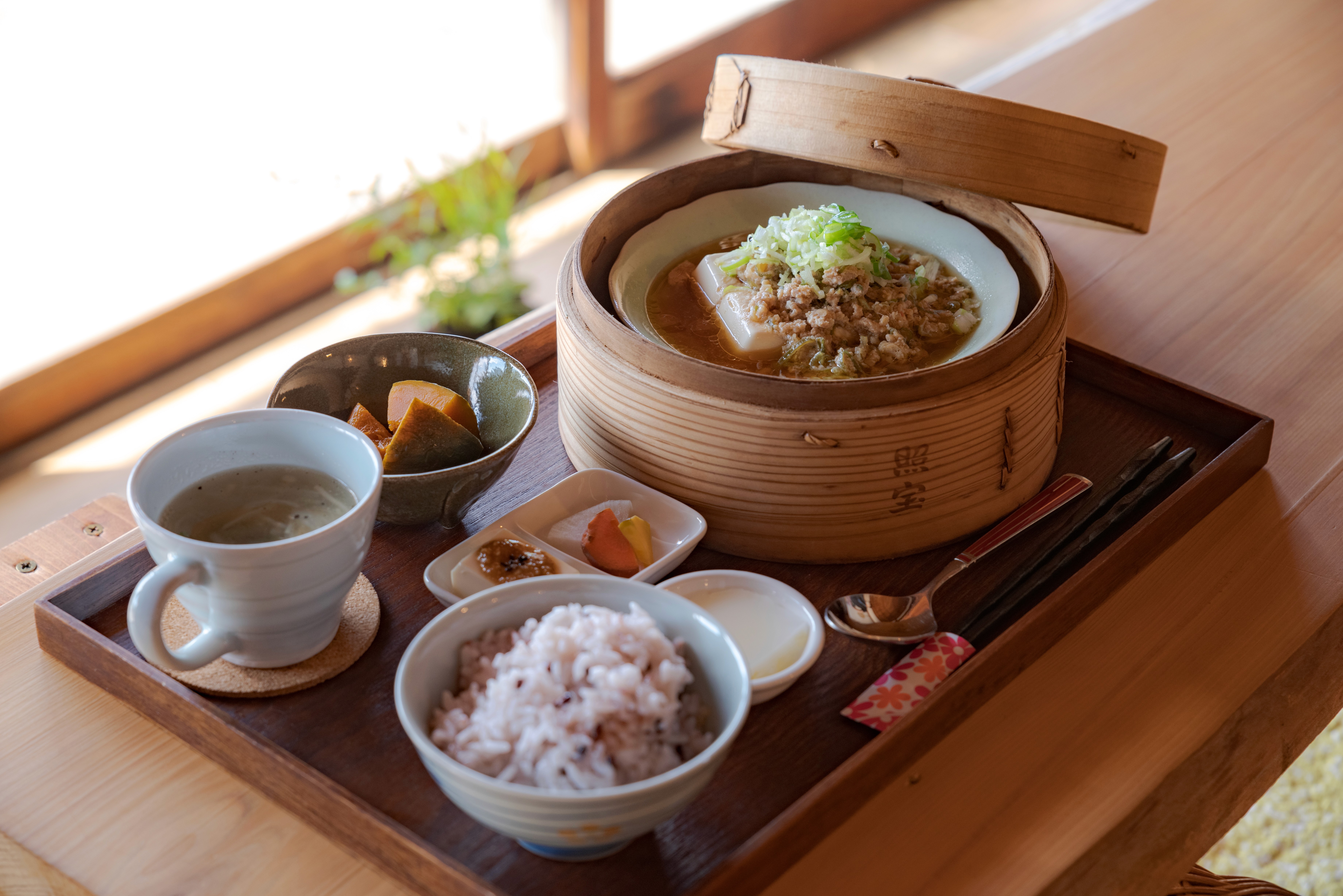 Japanese set meal with rice, soup, vegetables, and tofu