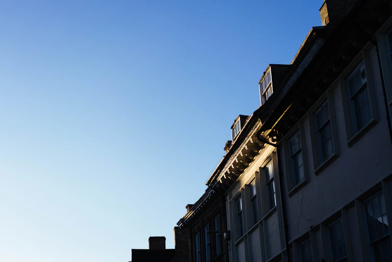 Row of town houses along a street under a clear sky