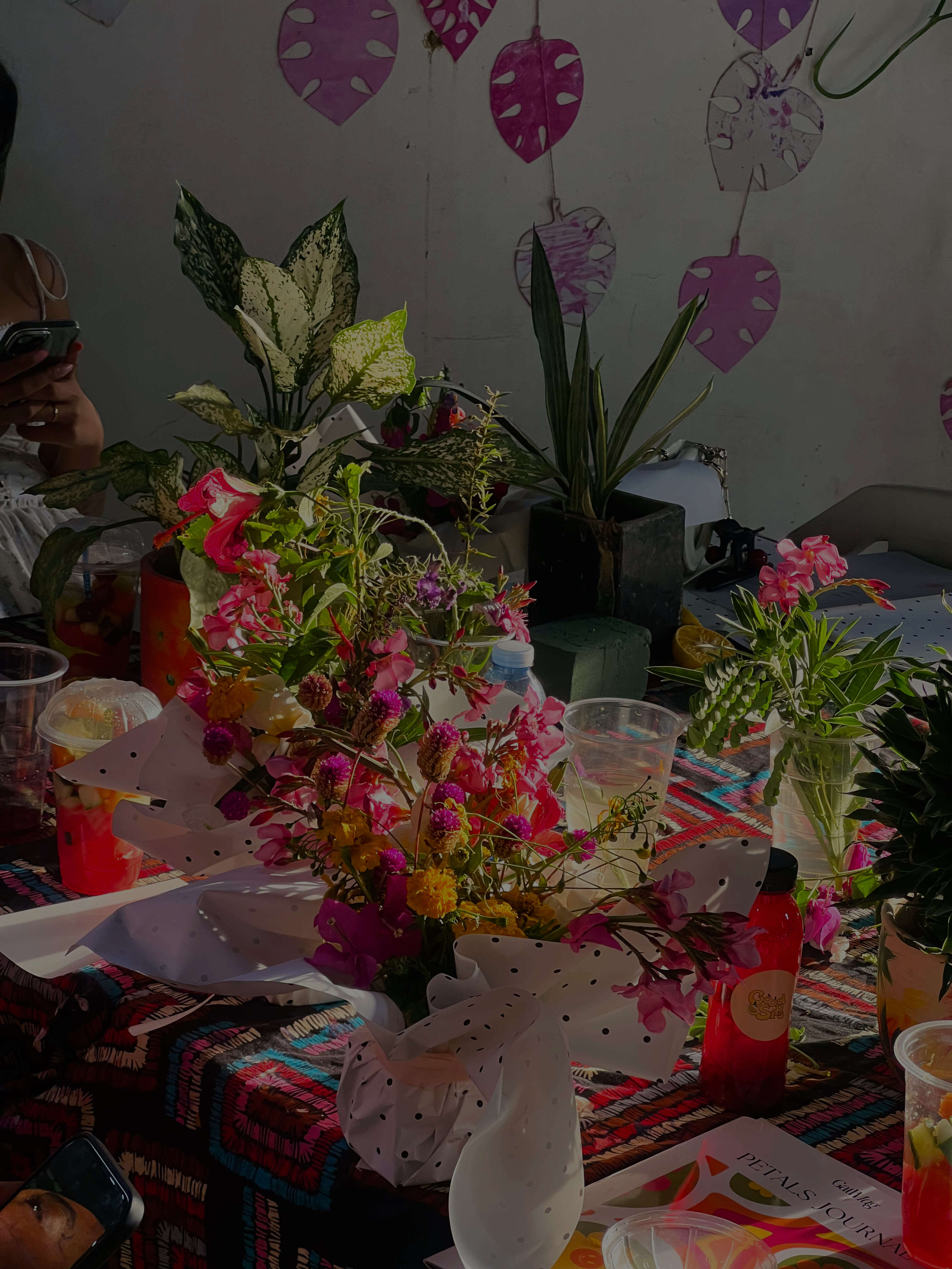 Dimly lit room with sunlight filtering through curtains, casting shadows on a green marble table with a single plate of pasta in the center.