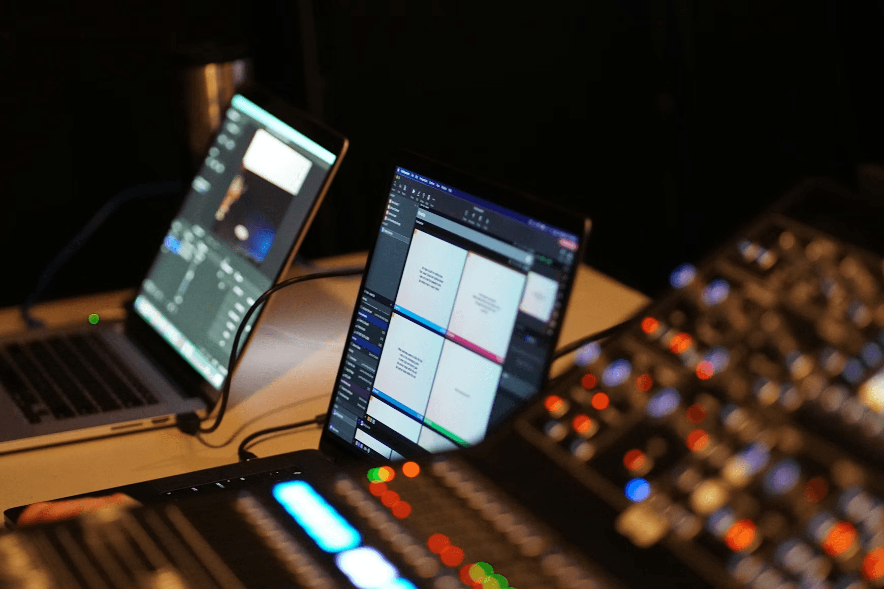 Laptops displaying video editing software and audio mixer controls