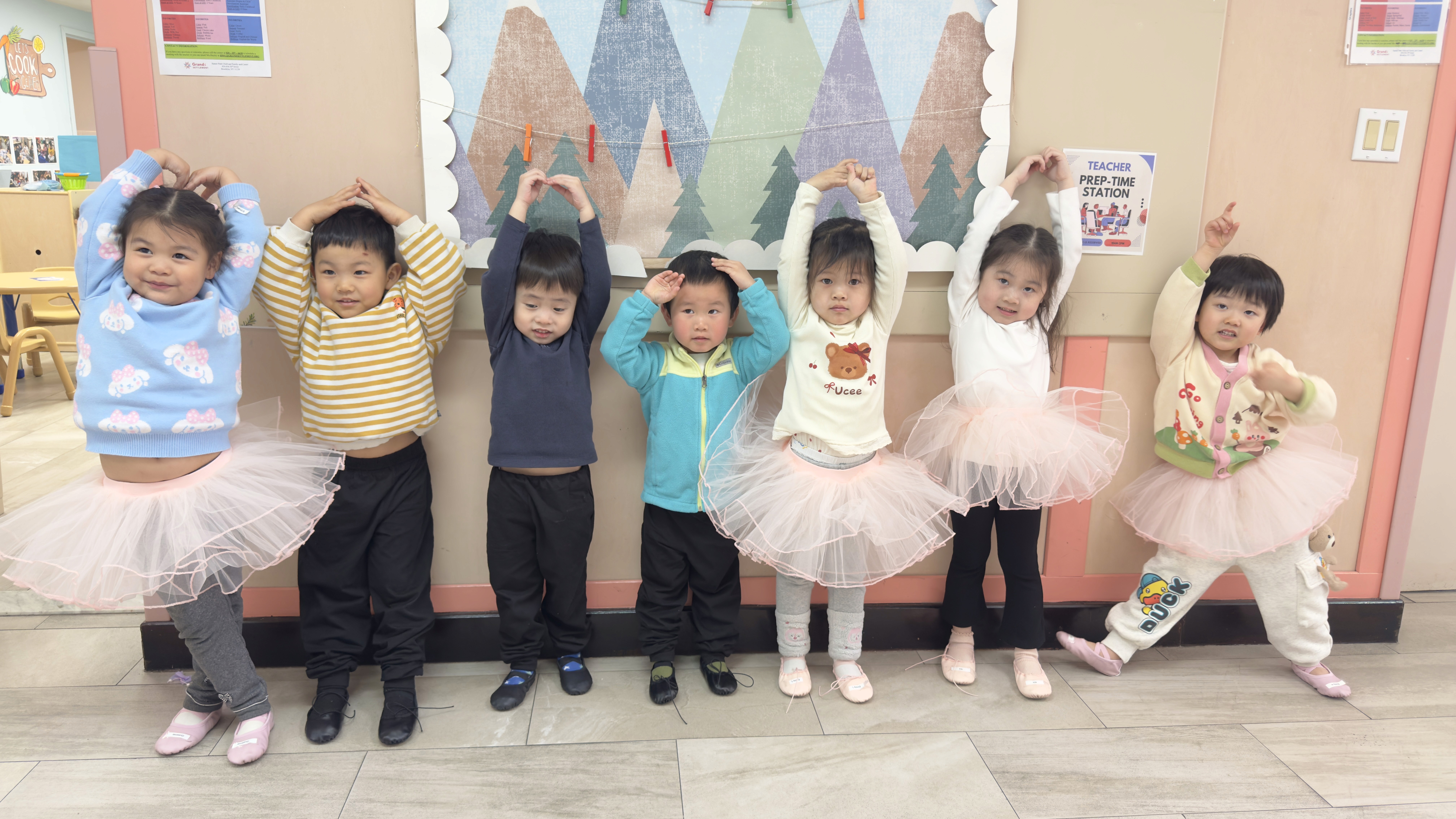 Preschoolers practicing their ballet moves in class.