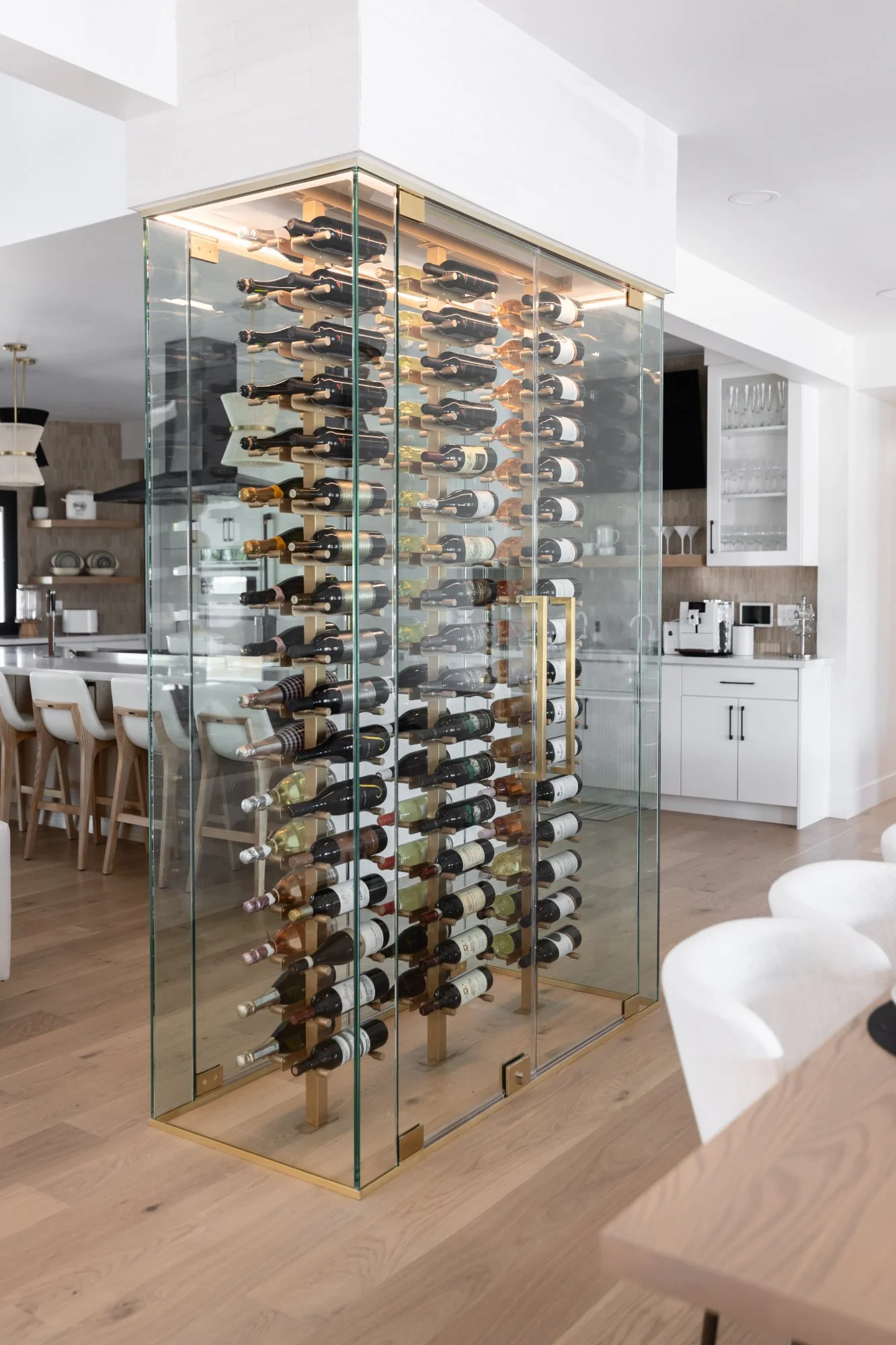 nfinity pool blending into the ocean view, minimalist sun loungers in soft neutral fabric, curved architecture