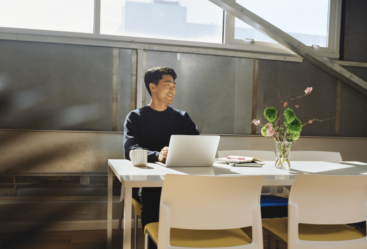 Man working on his computer in a bright office.