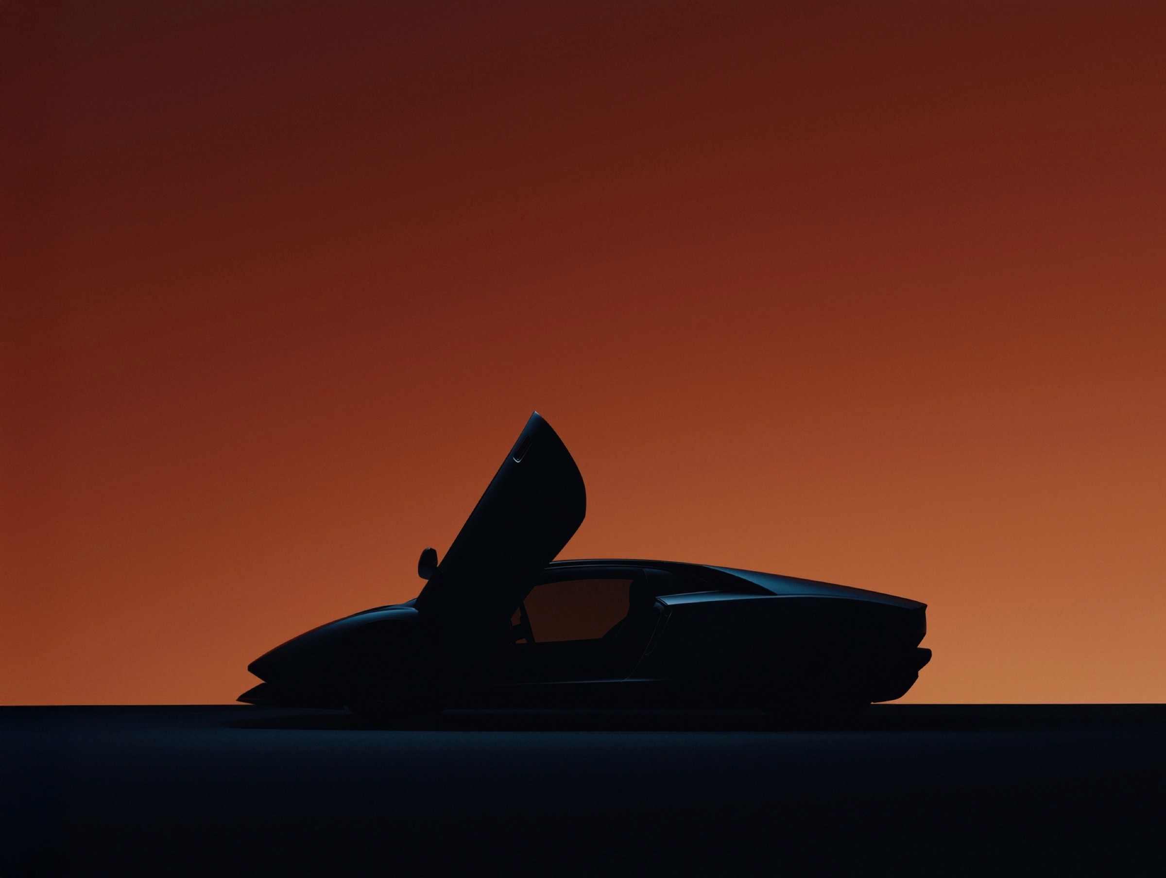 Sleek sports car silhouette against gradient sunset