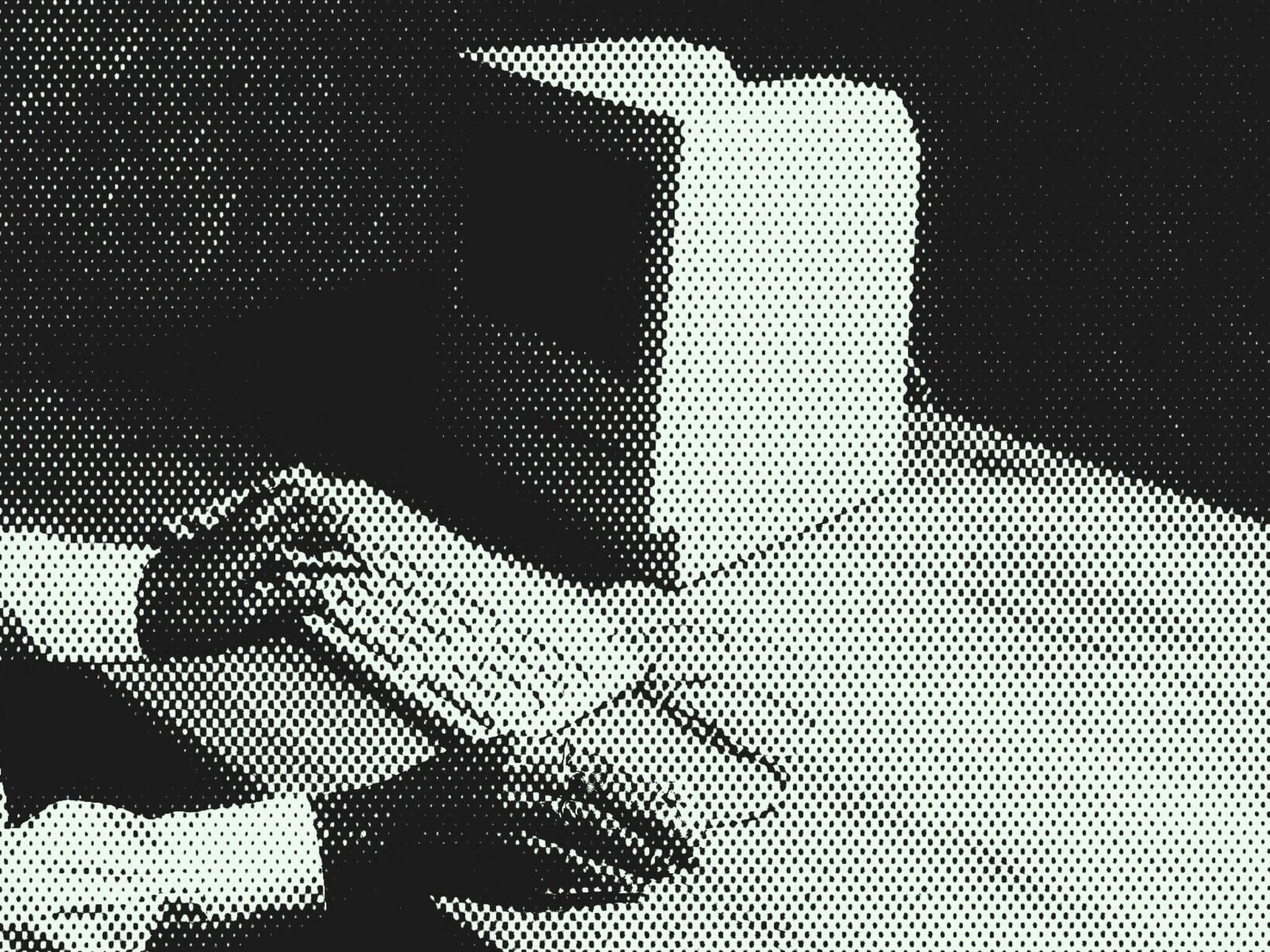 Halftone image of hands typing on an early computer keyboard, symbolizing the historical foundations of technology and the future growth of quantum venture capital investing.