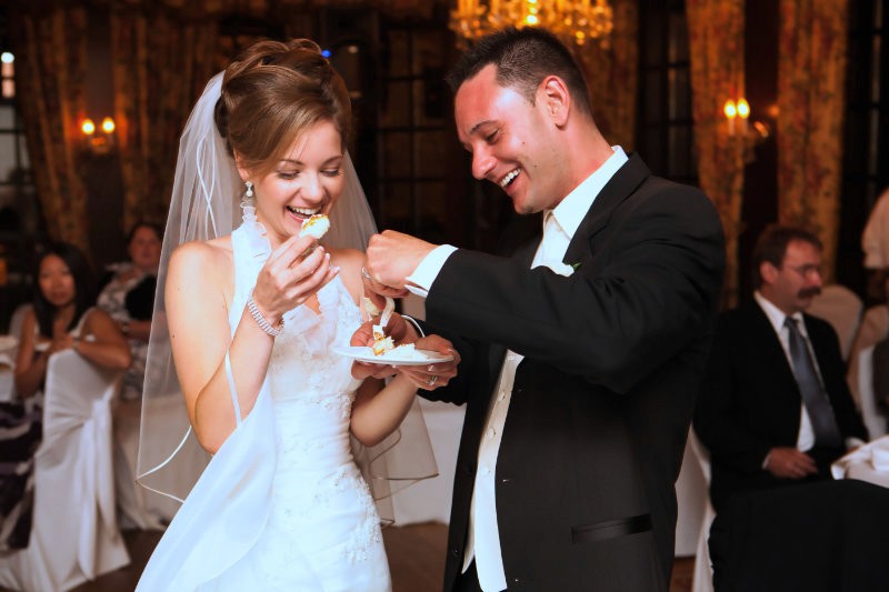 Bride and groom cutting their wedding cake.