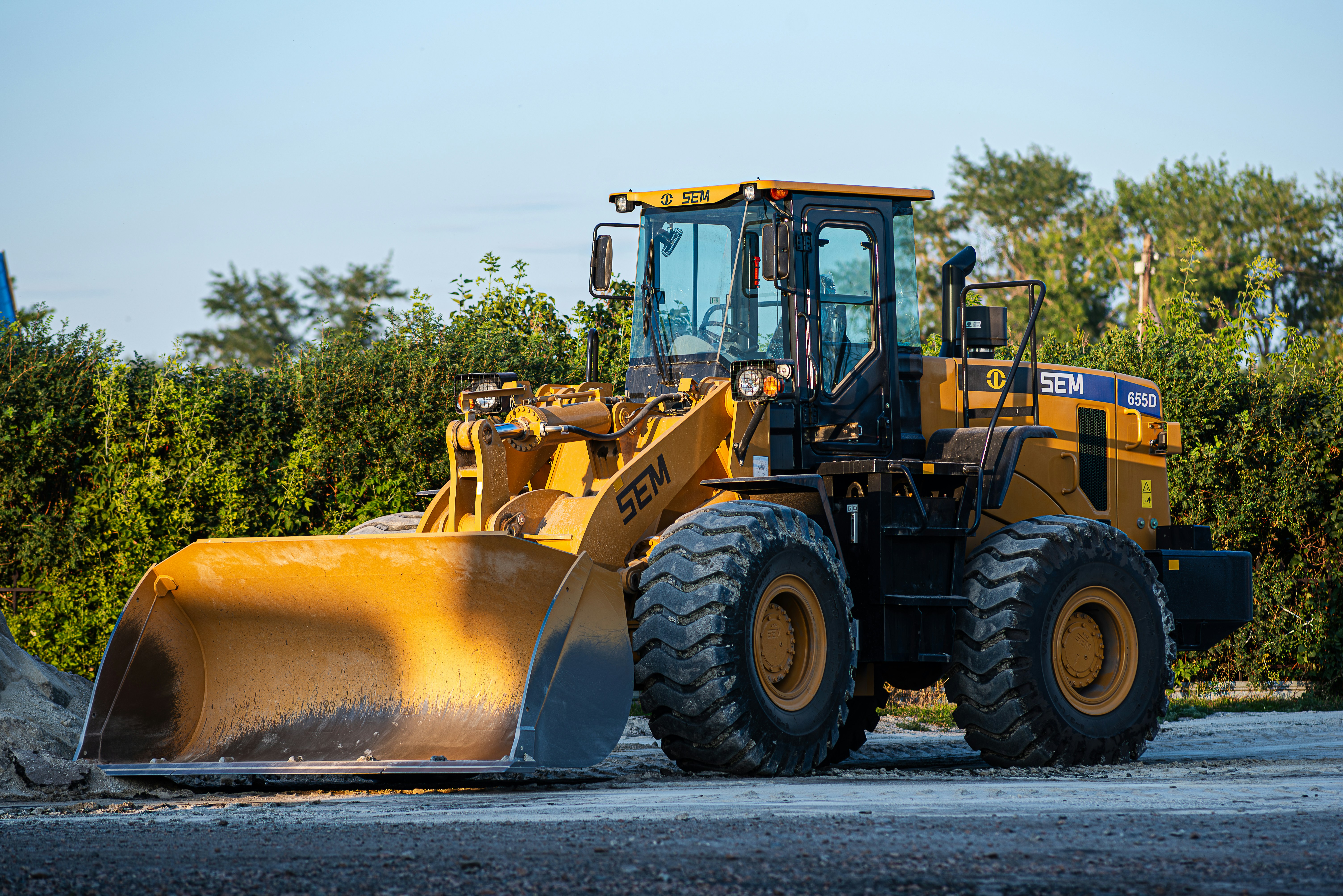 a large yellow bulldozer is parked on the side of the road