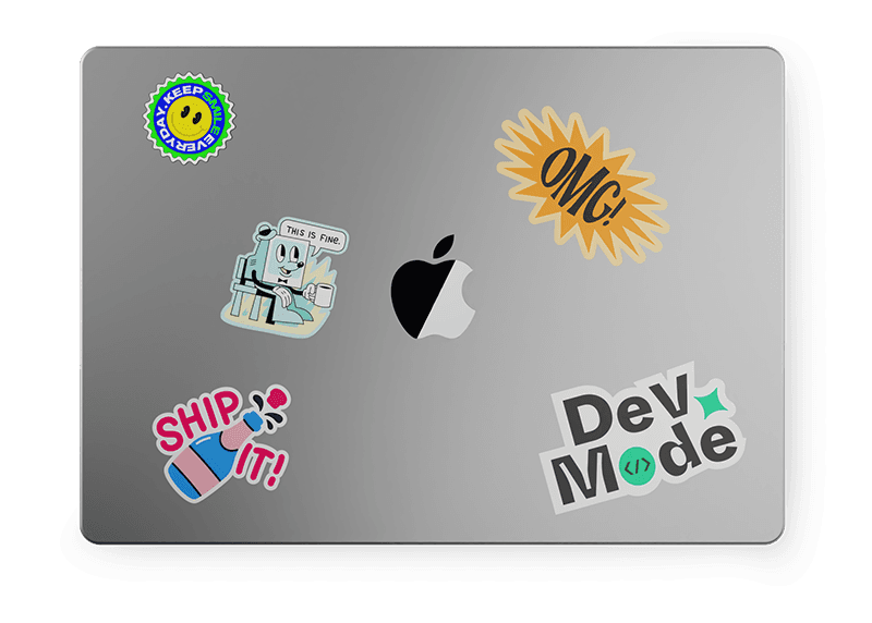 A silver laptop covered with various colorful stickers, including a sun, a cartoon character, and an Apple logo.