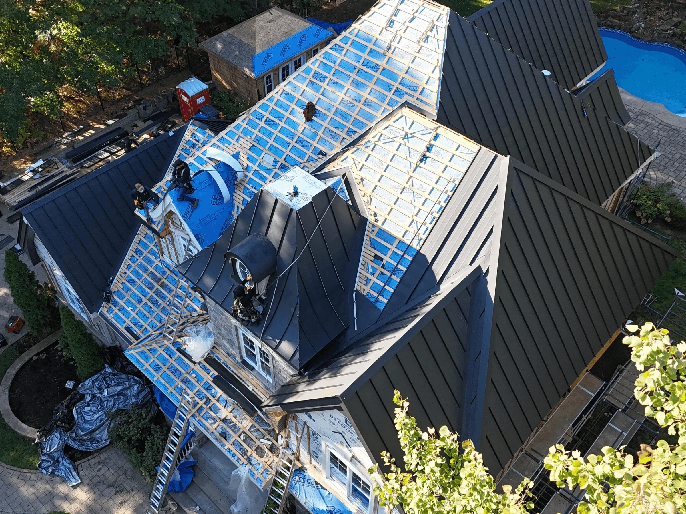 Installation de toiture métallique en cours sur une maison résidentielle à Montréal - vue aérienne