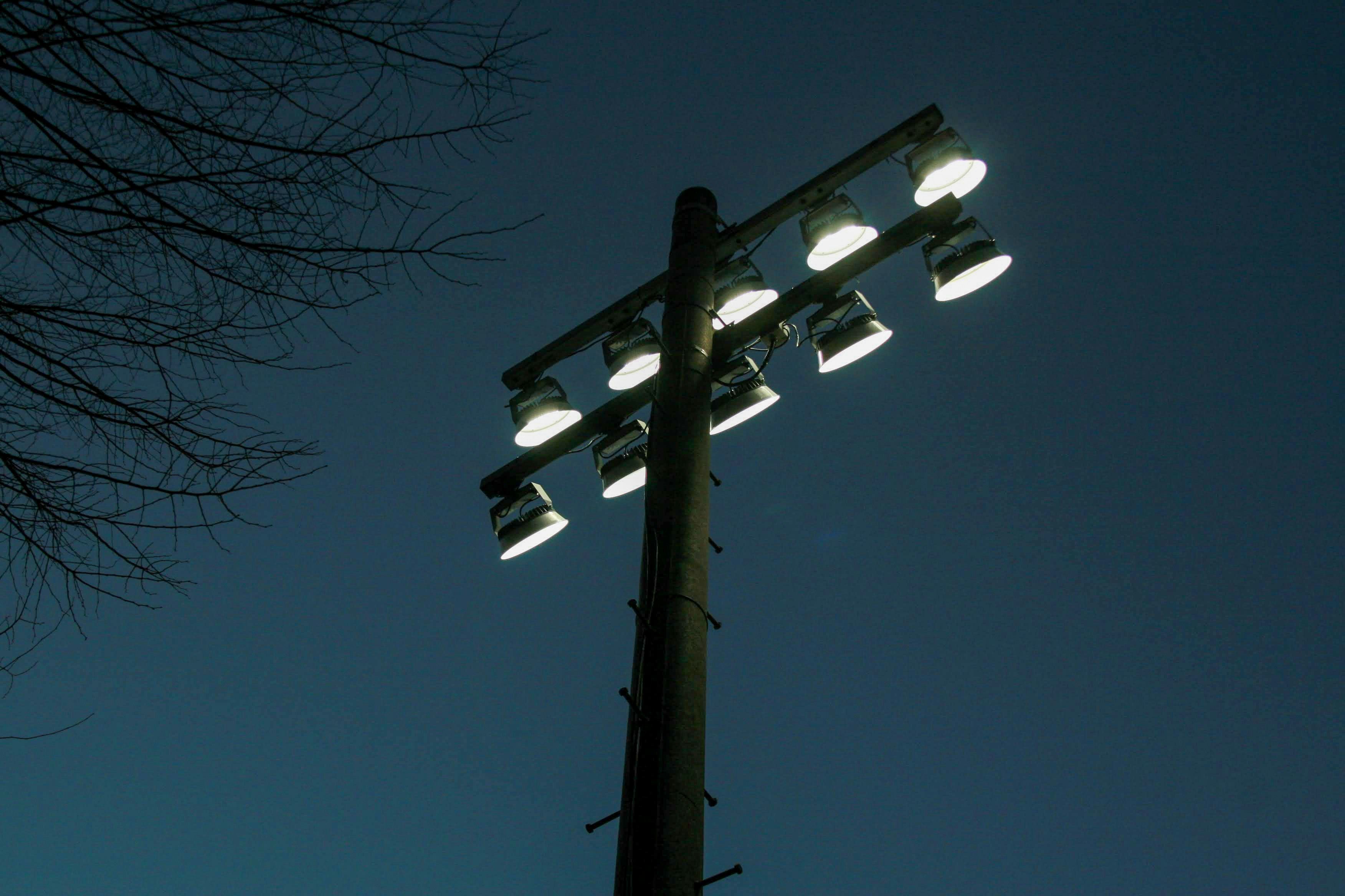 a street light with four lights on top of it