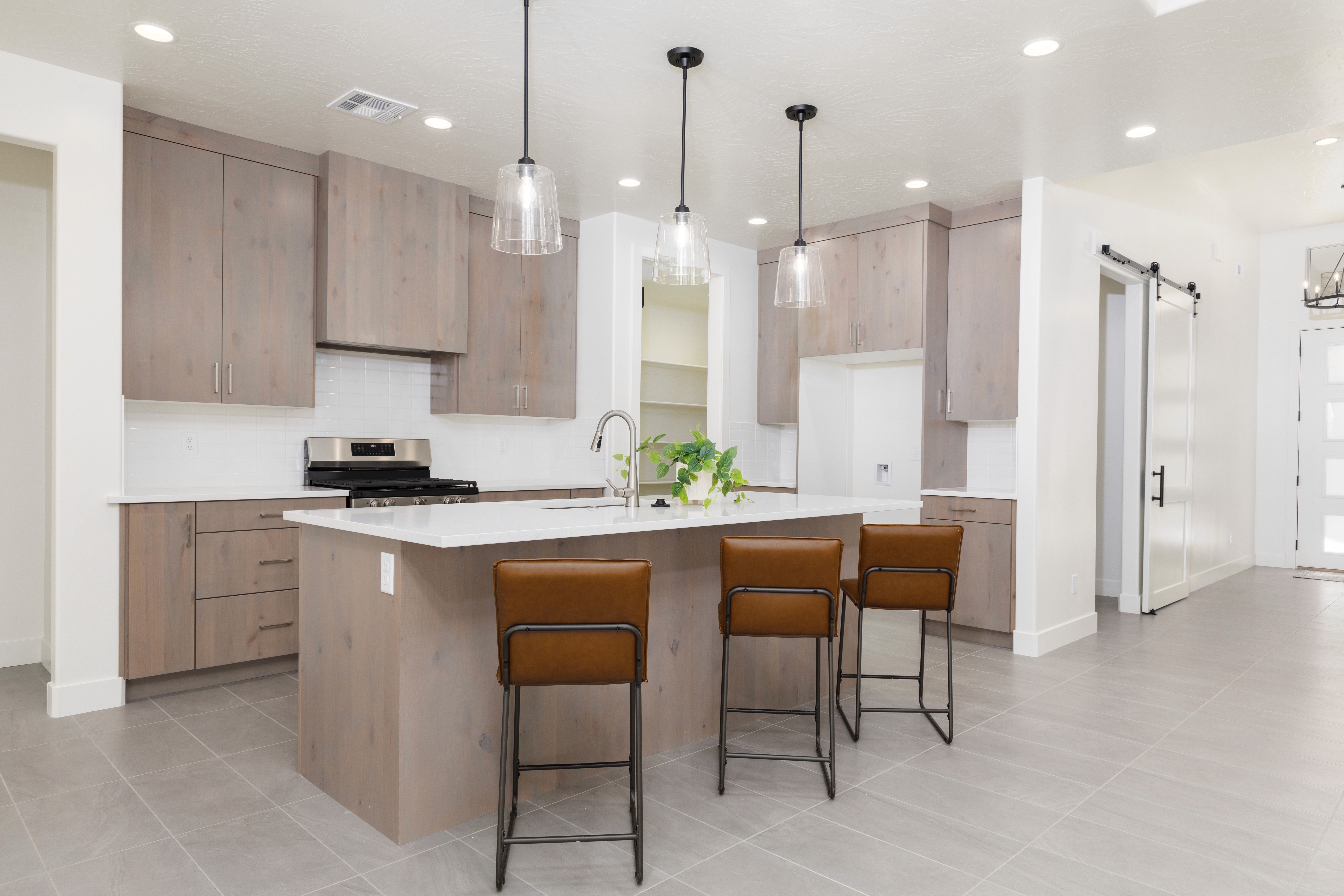 Kitchen in a Hurricane, Utah home with light wood cabinetry, white quartz countertops, and a complimentary wall color.