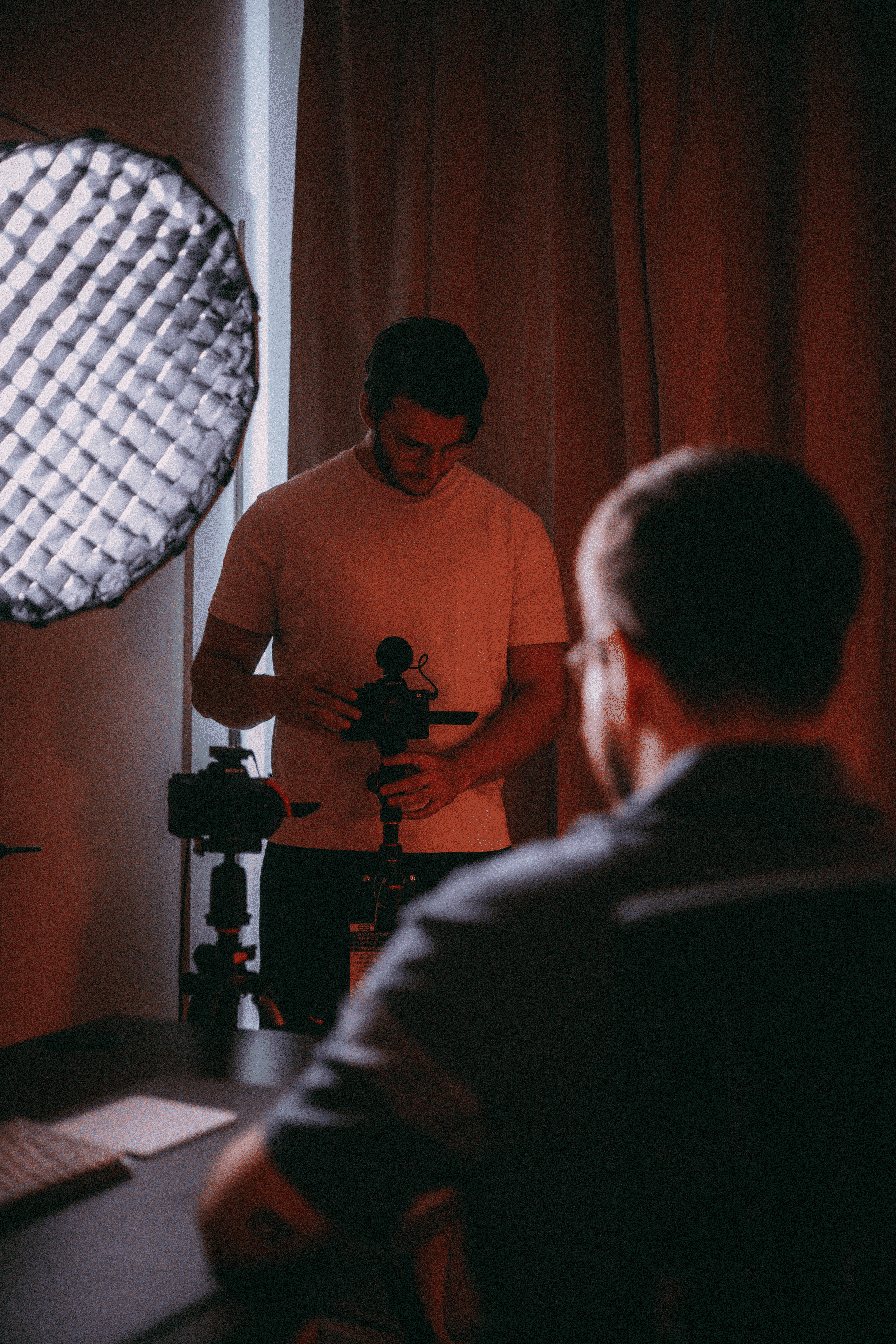 Behind-the-scenes video shoot with camera, boom microphone, and crew