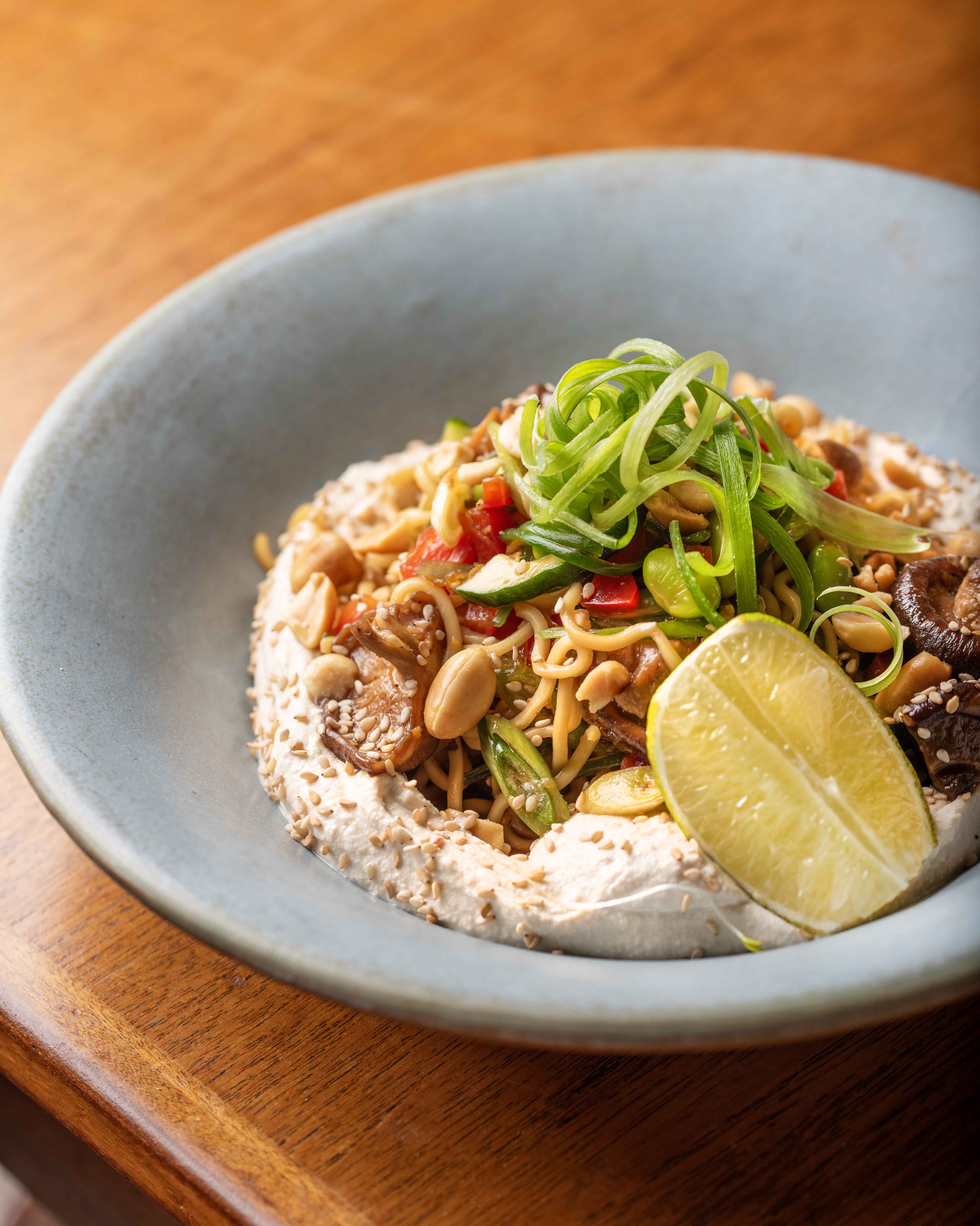 Bol de fideos vegetarianos con cacahuetes y lima en Faire. Tapas & Wine