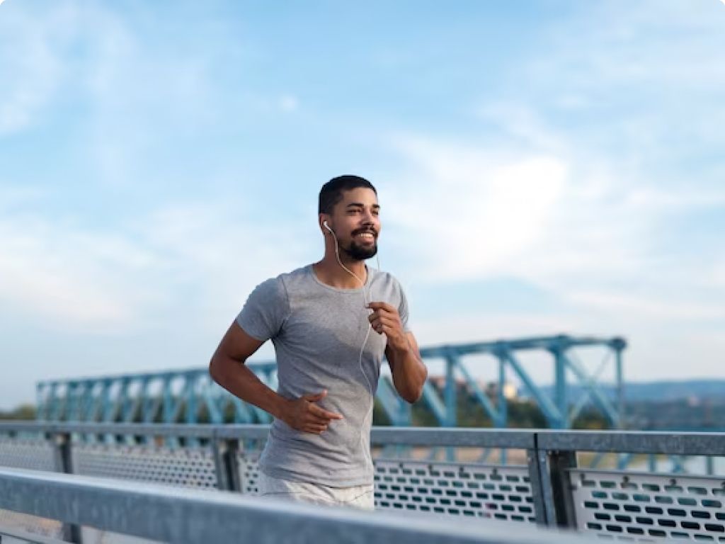 A man jogging on a bridge, enjoying a scenic workout session.