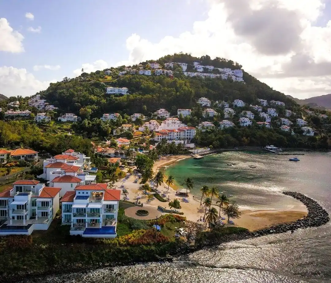 Completed beachfront villas at Windjammer Landing Resort in St. Lucia with terracotta roofs, plunge pools, and Caribbean Sea views.