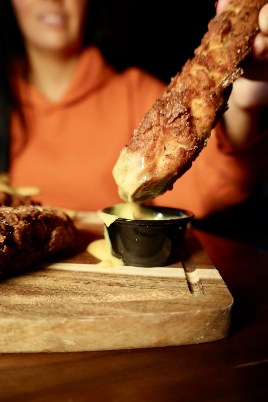 A chef placing fried chicken in a take away box