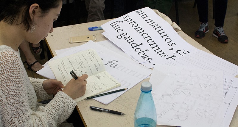 student working on a lettering exercise