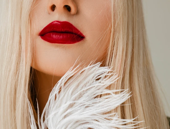 A close-up of a blonde woman with bright red lipstick