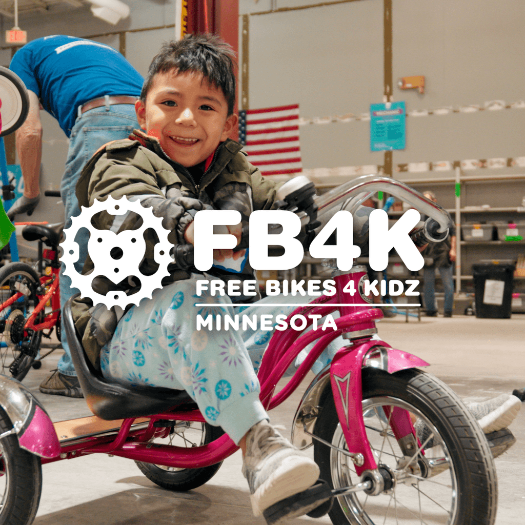 Volunteers helping children select and repair bikes at the Free Bikes 4 Kidz event in Minnesota.