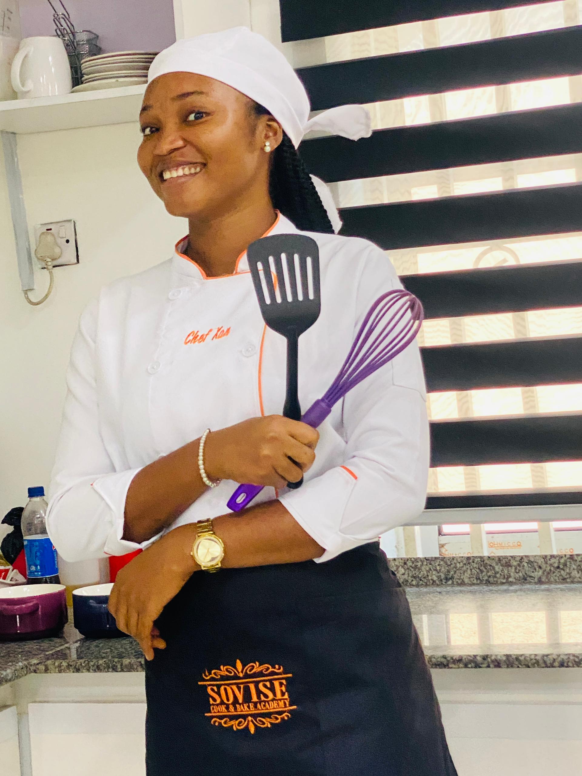 Chef Xan holding spatulas