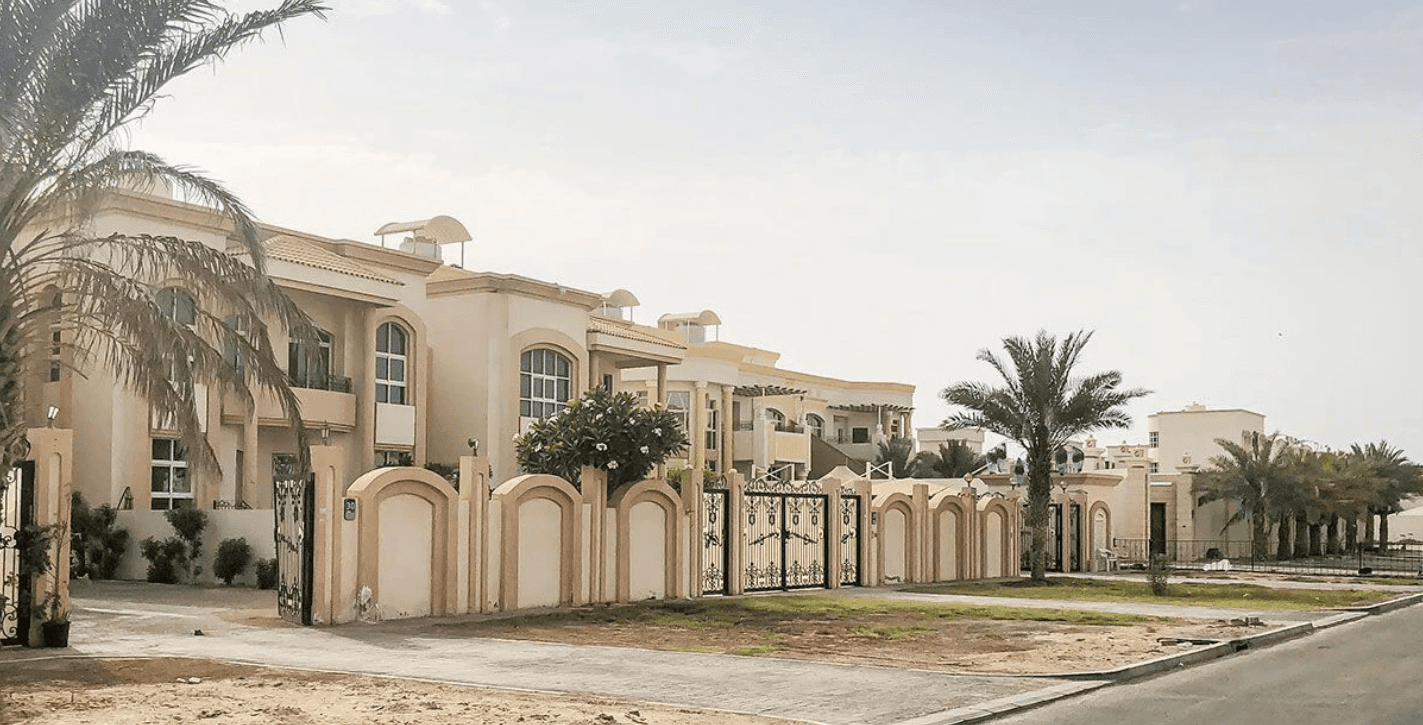 A prominent building accompanied by a vast parking area in Mohammed Bin Zayed City.
