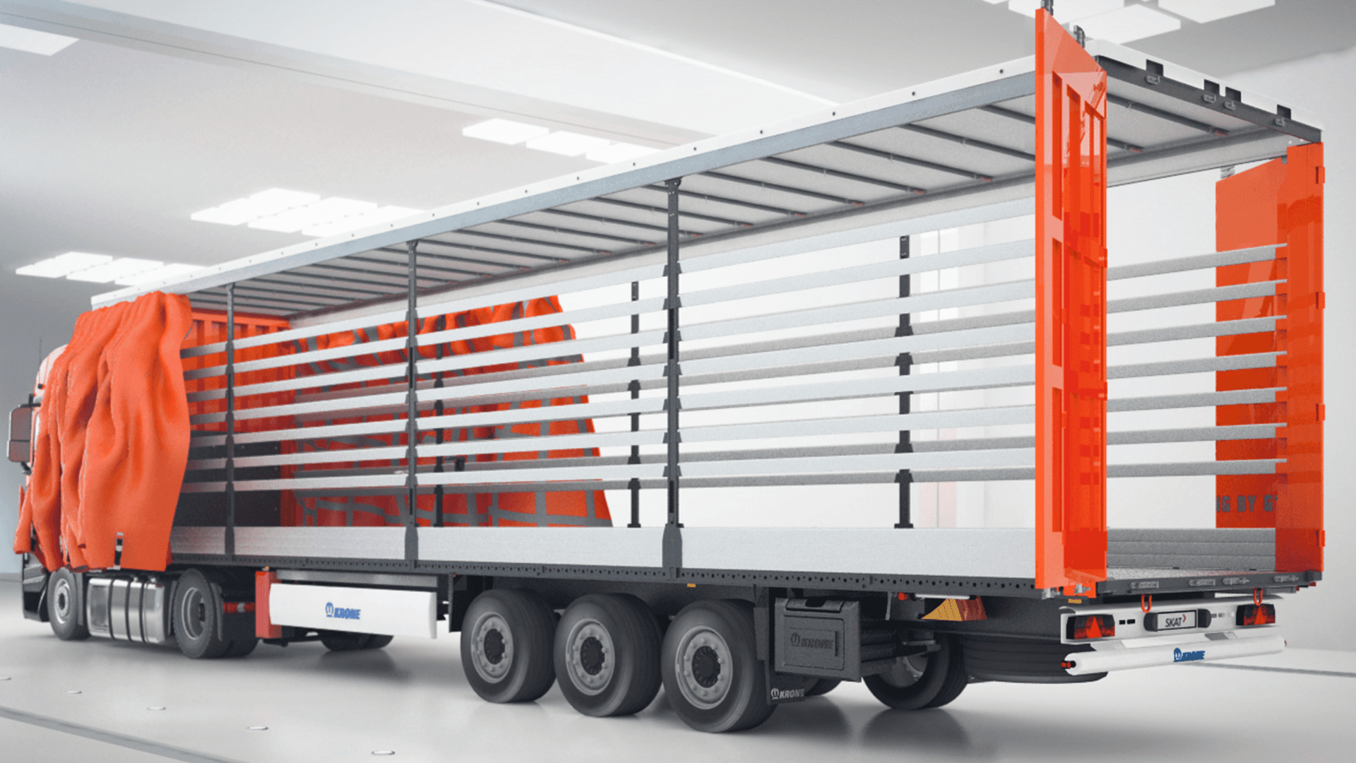  Nowoczesna naczepa ciężarowa z rozsuniętymi bokami i uniesionym dachem, prezentująca wnętrze do załadunku, w jasnej przestrzeni magazynowej.