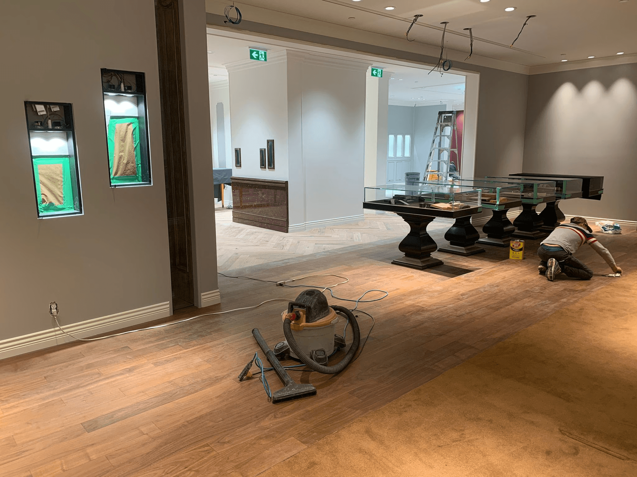 a hallway with a bench and potted plants