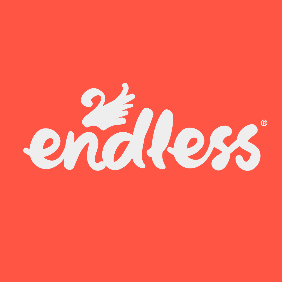 White branded cap with turquoise logo placed on fresh lemons in a red bowl