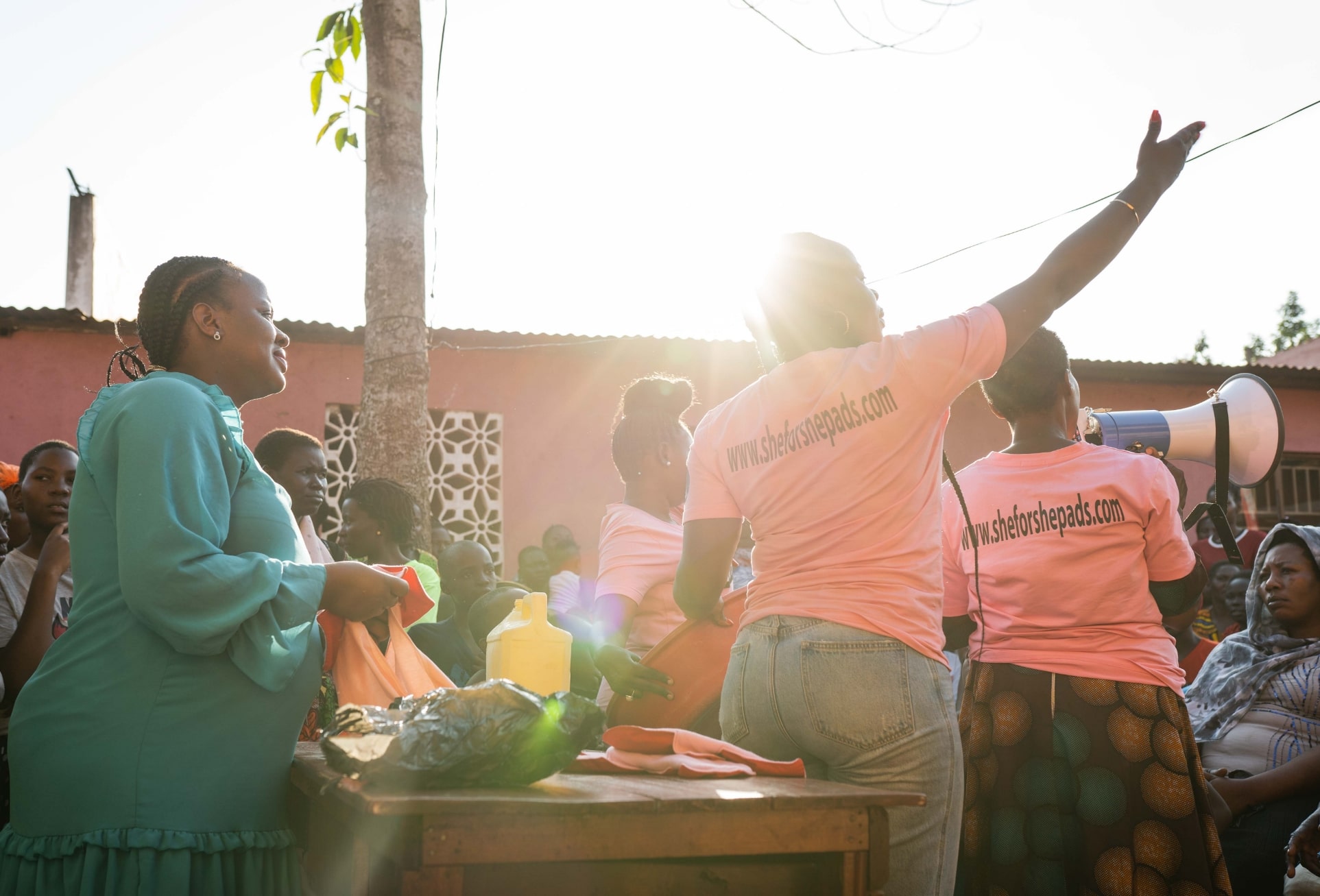 “The SHE FOR SHE founder and a volunteer distributing products.