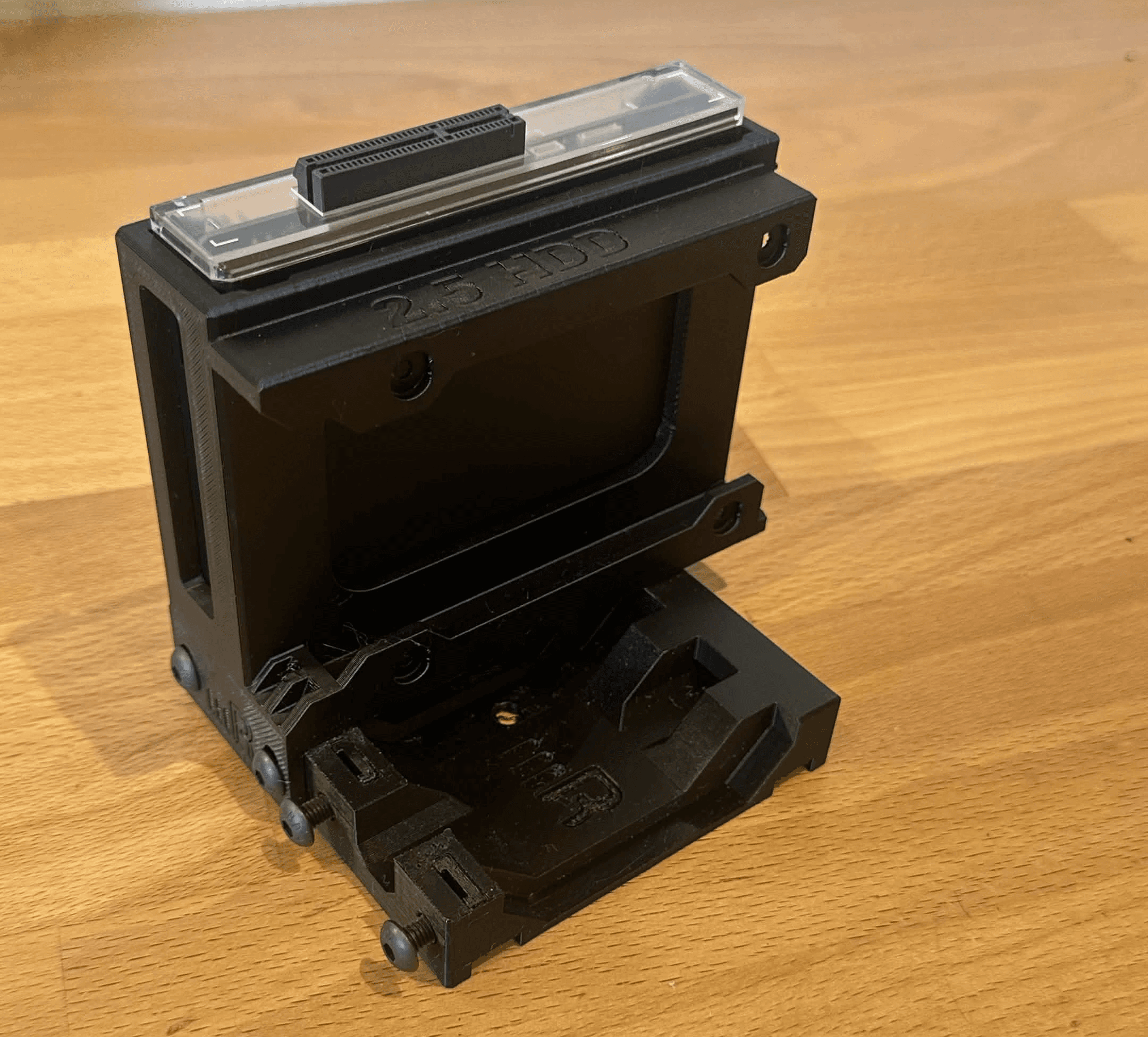 black 3D-printed microRACK with separate spaces for a ZimaBlade and a 2.5-inch storage drive.