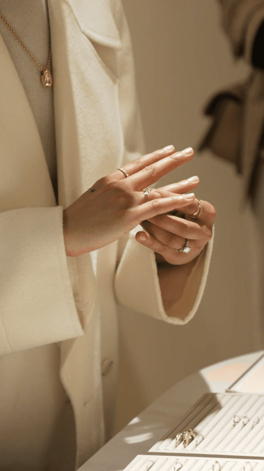 Bride sitting on ground against wall, groom standing nearby